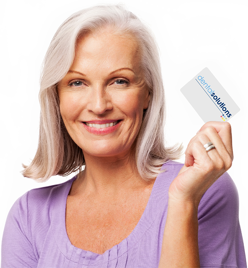 Woman holding a Dental Solutions membership card.